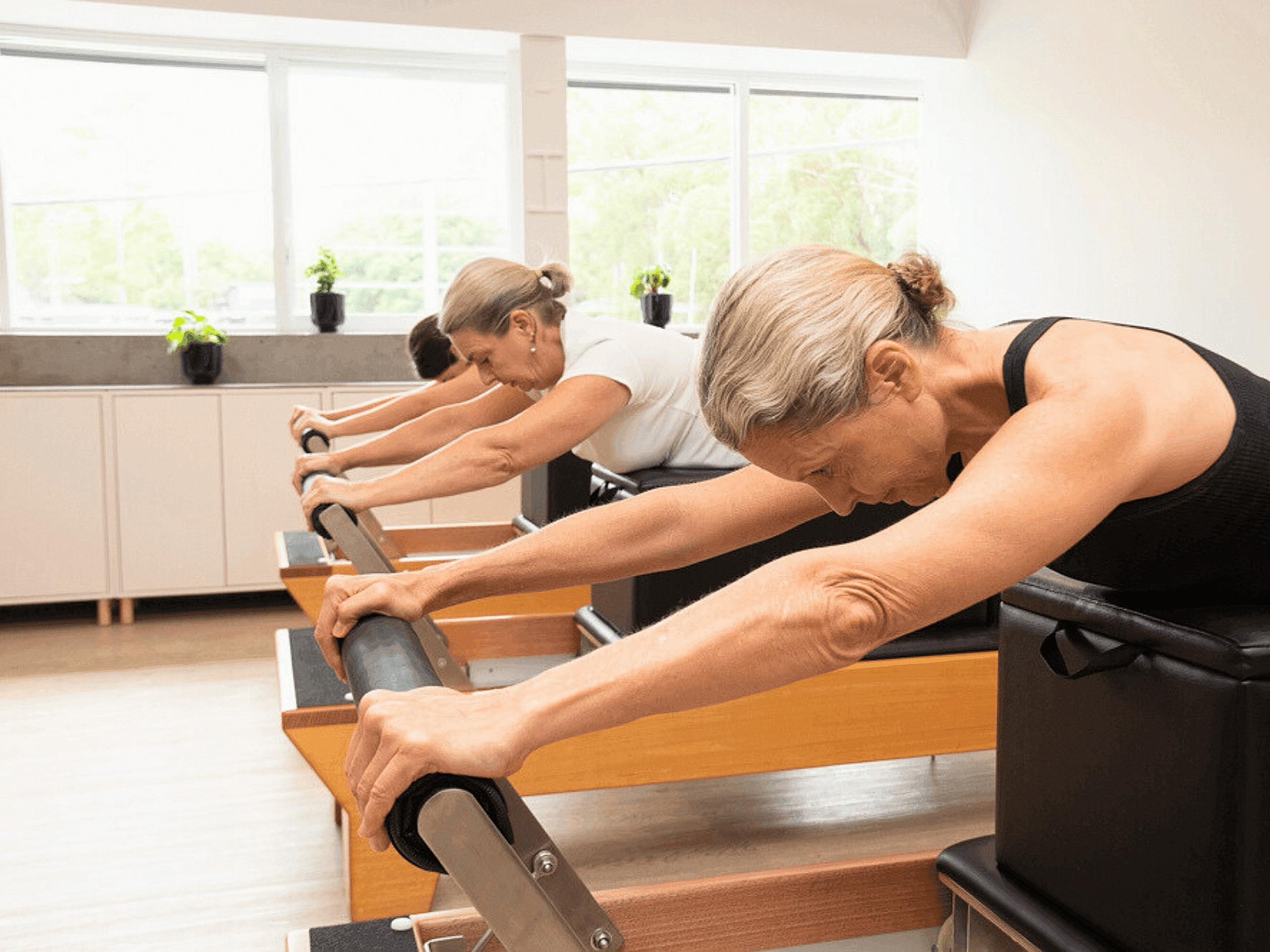 Reformer Pilates class, shoulder press work. Reformer Pilates studio located in North Brisbane, servicing Albion, Ascot, Hamilton, Hendra, Clayfield, Lutwyche, Windsor and Newstead.